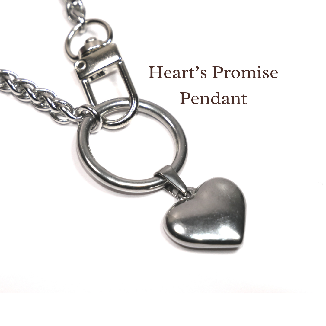 Heart-shaped pendant on a chain with 'Heart's Promise' text on a white background. Devotion Clasp Collar. Trad wife. Handcrafted biblical womanhood jewelry USA. Traditional wife faith necklace.