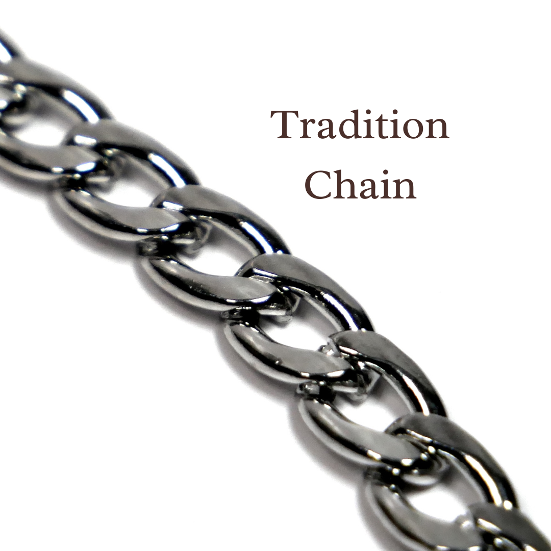 Close-up of a silver chain with 'Tradition Chain' text on a white background. Handcrafted biblical womanhood jewelry USA. Devotion Clasp Collar.