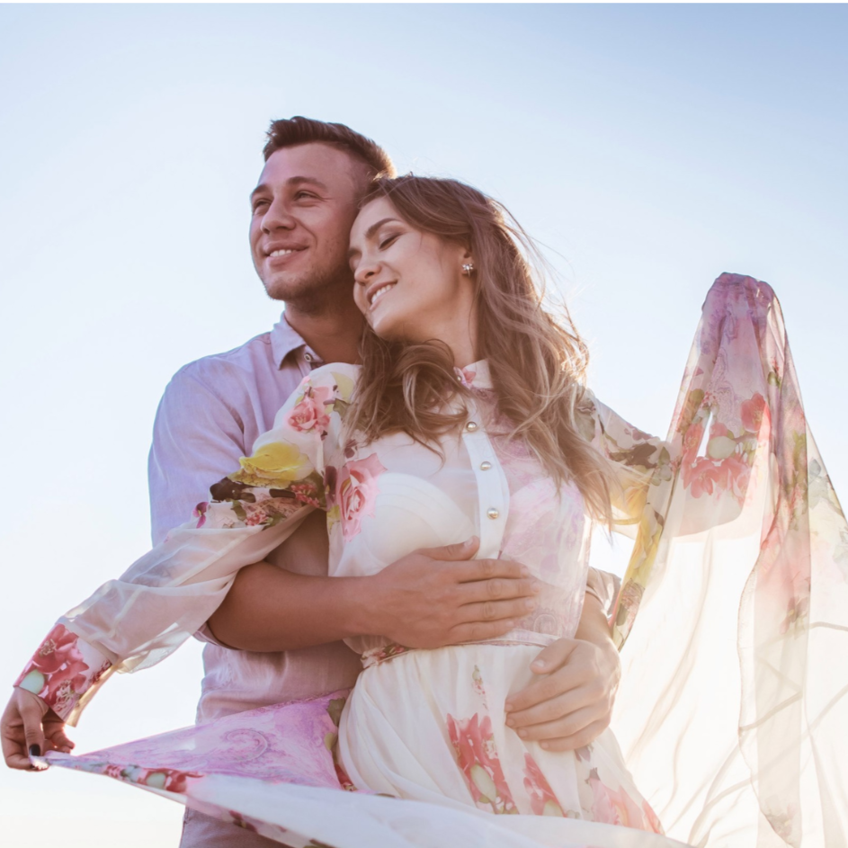 Couple embracing with a clear blue sky background